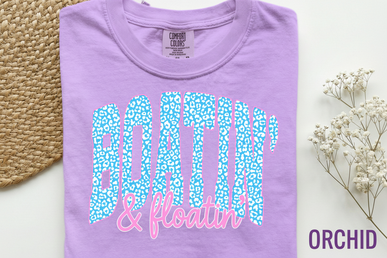Orchid purple Comfort Colors T-shirt with blue leopard-print "BOATIN" and pink "floatin'" text on front.