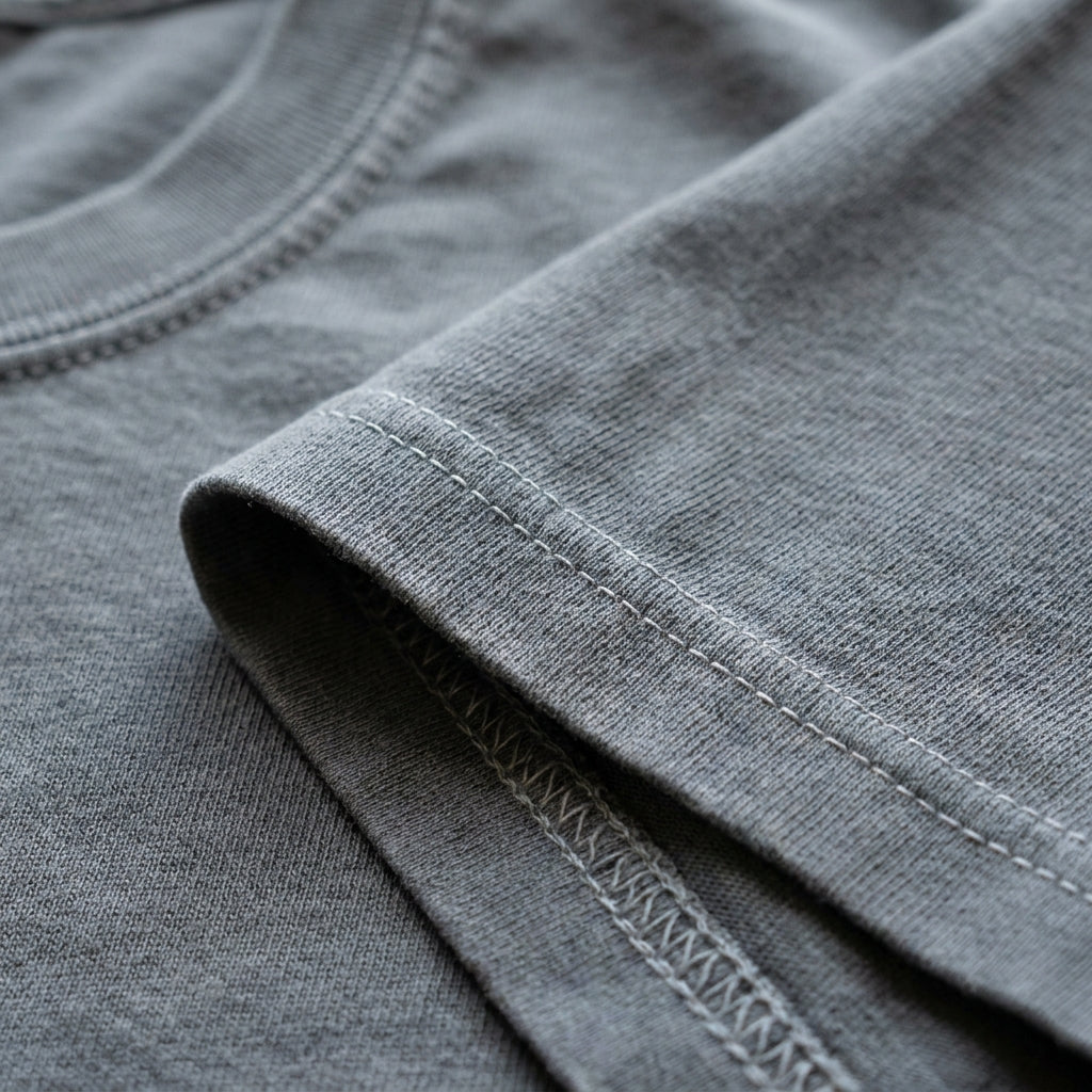Close-up of the sleeve hem and neckline of a Custom State Pride T-Shirt displaying double-needle stitching and vintage look.