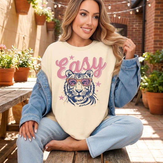 Full-body shot of a model wearing the Retro Easy Tiger Graphic Tee with denim jacket and jeans outdoors, highlighting its relaxed fit.