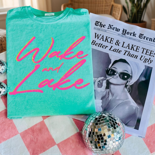 Wake & Lake T-Shirt displayed in a cozy, inviting living room setting with warm natural lighting.